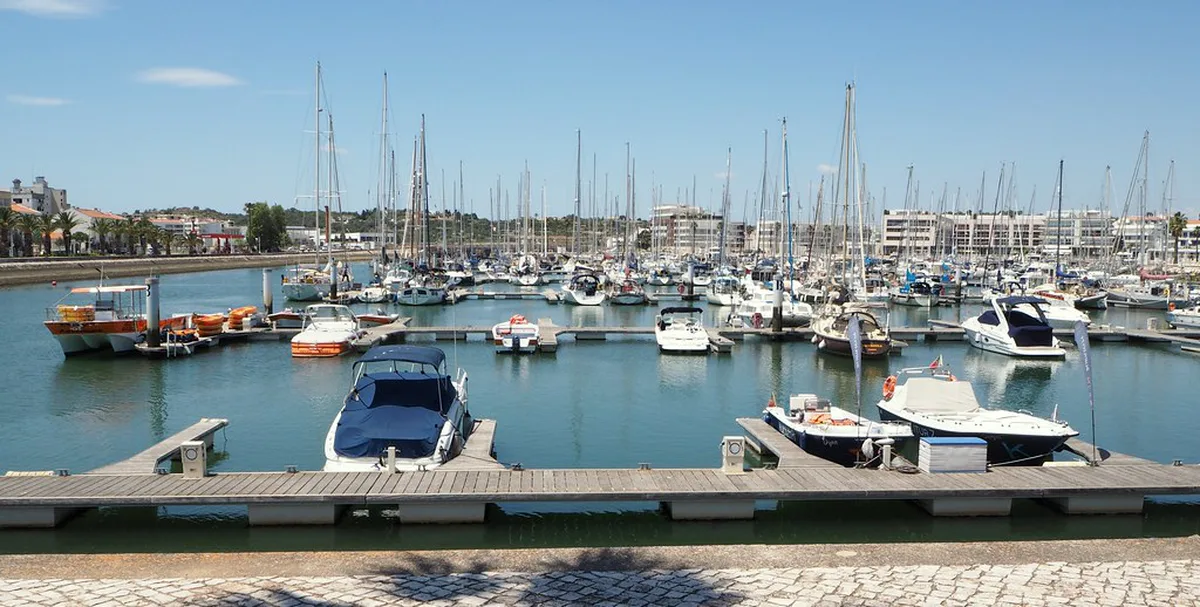 Boats moored along the marina waterfront in Lagos, Algarve
