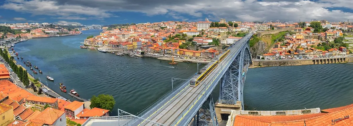 A vintage tram beside the river in Porto, Portugal